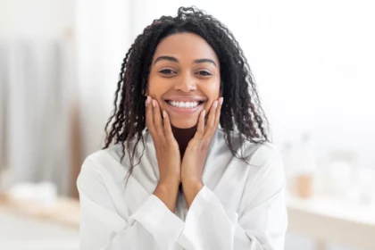 African woman smiling after using QNET's Physio Radiance Expert