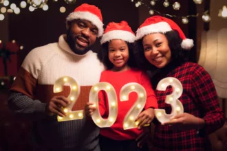 African family holding up a happy new year 2023 sign