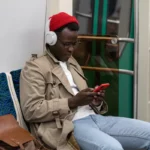 African man listening to QBUZZ's audio posts