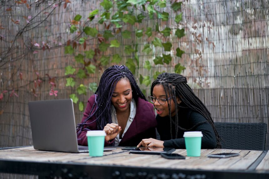 Two African young women working together on their computer